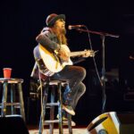 JOHN CORABI AT THE RYMAN: WEAVING SONGS & TALES FROM HIS JOURNEYS